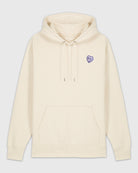 Hoodie beige avec une broderie mauve en forme de comprimé de B12 en coeur.