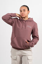 Mannequin femme portant un hoodie vieux rose avec une broderie blanche Steak de soja et lait d’amande. 